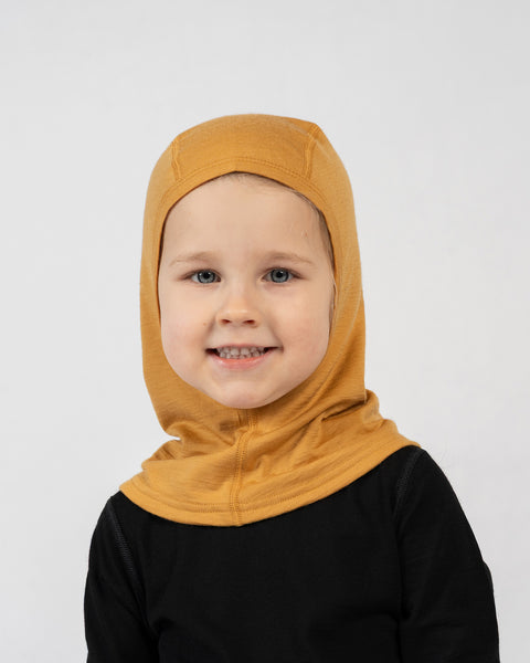 Kids merino wool balaclava in mustard yellow, breathable and soft merino head covering for outdoor wear.