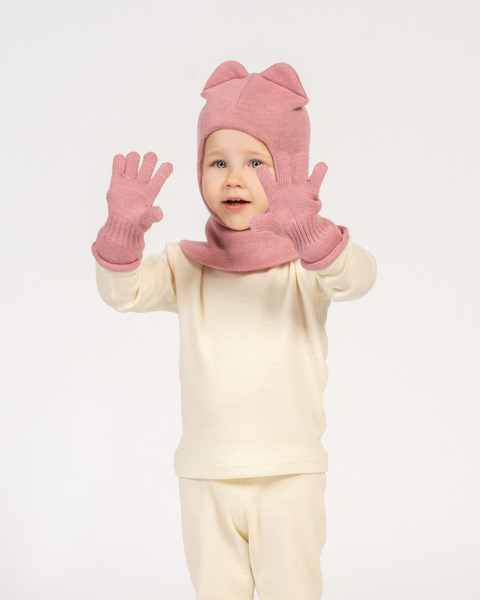 Child with wearing pink knitted cashmere gloves and balaclava.