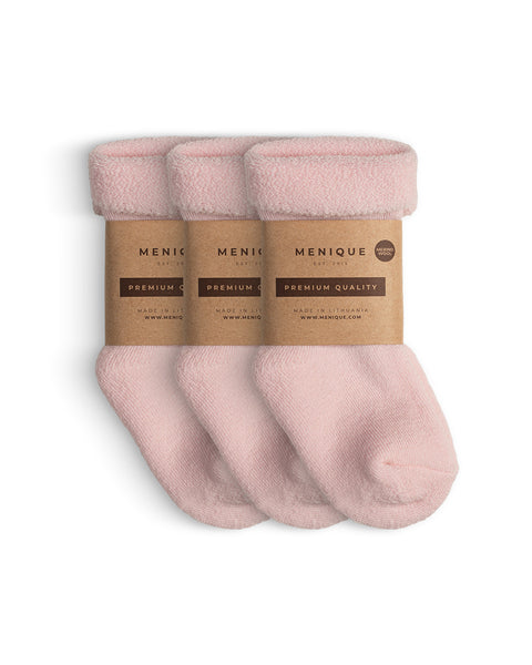 A 3-pack of kids’ pink sherpa-lined merino wool socks with Menique branding.