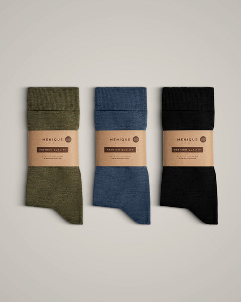 The menique men's merino wool crew socks in all available colors, with packaging.