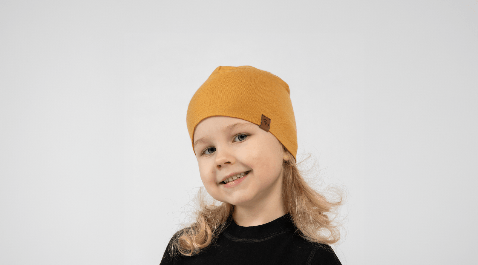 a girl wearing light blue knitted merino wool beanie