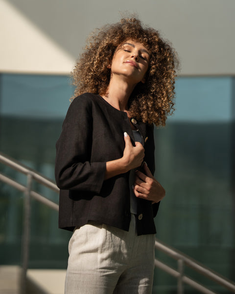 Woman with curly hair wearing black linen jacket Alice