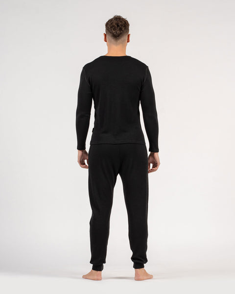 The menique men's merino wool 250gsm long sleeve top and jogger sweatpants set in black color.