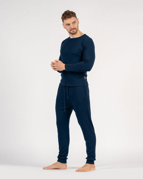 The menique men's merino wool 250gsm long sleeve top and jogger sweatpants set in dark blue.