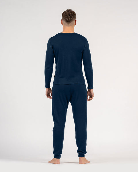 The menique men's merino wool 250gsm long sleeve top and jogger sweatpants set in dark blue color.