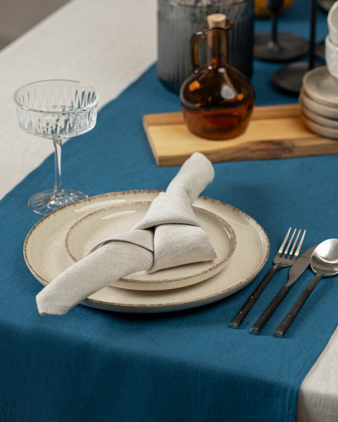 Elegant table with natural linen tablecloth and linen napkin, cobal blue table runner.