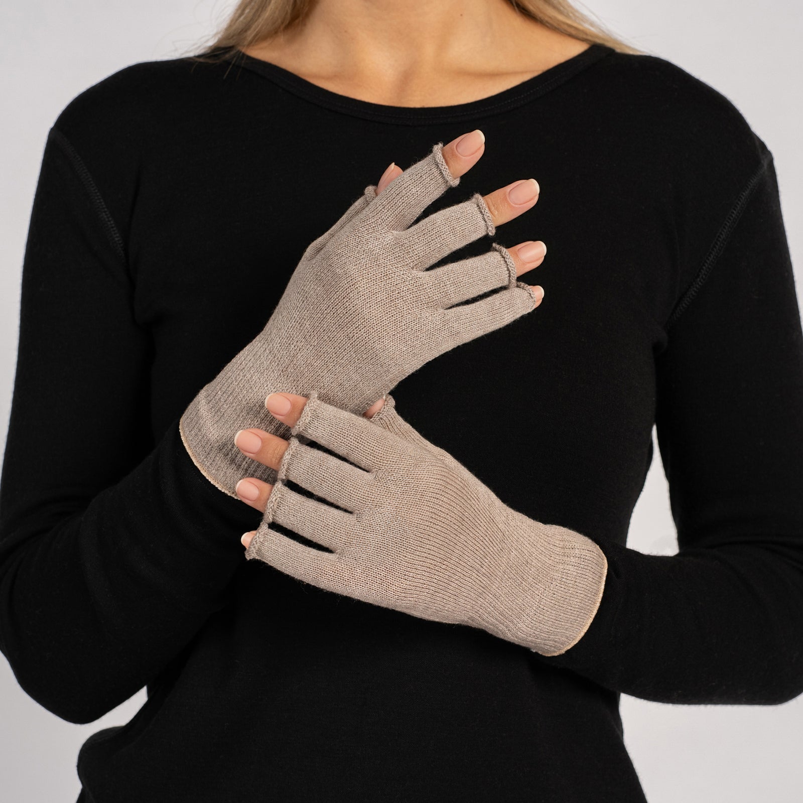 Woman running in spring park wearing beige merino wool fingerless running gloves, lightweight breathable gloves for temperature regulation and outdoor workouts