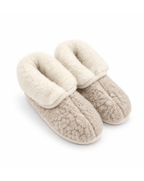 A pair of beige, textured fleece women's booties with the collars folded down to reveal a thick, fluffy cream-colored lining, displayed against a plain white background.
