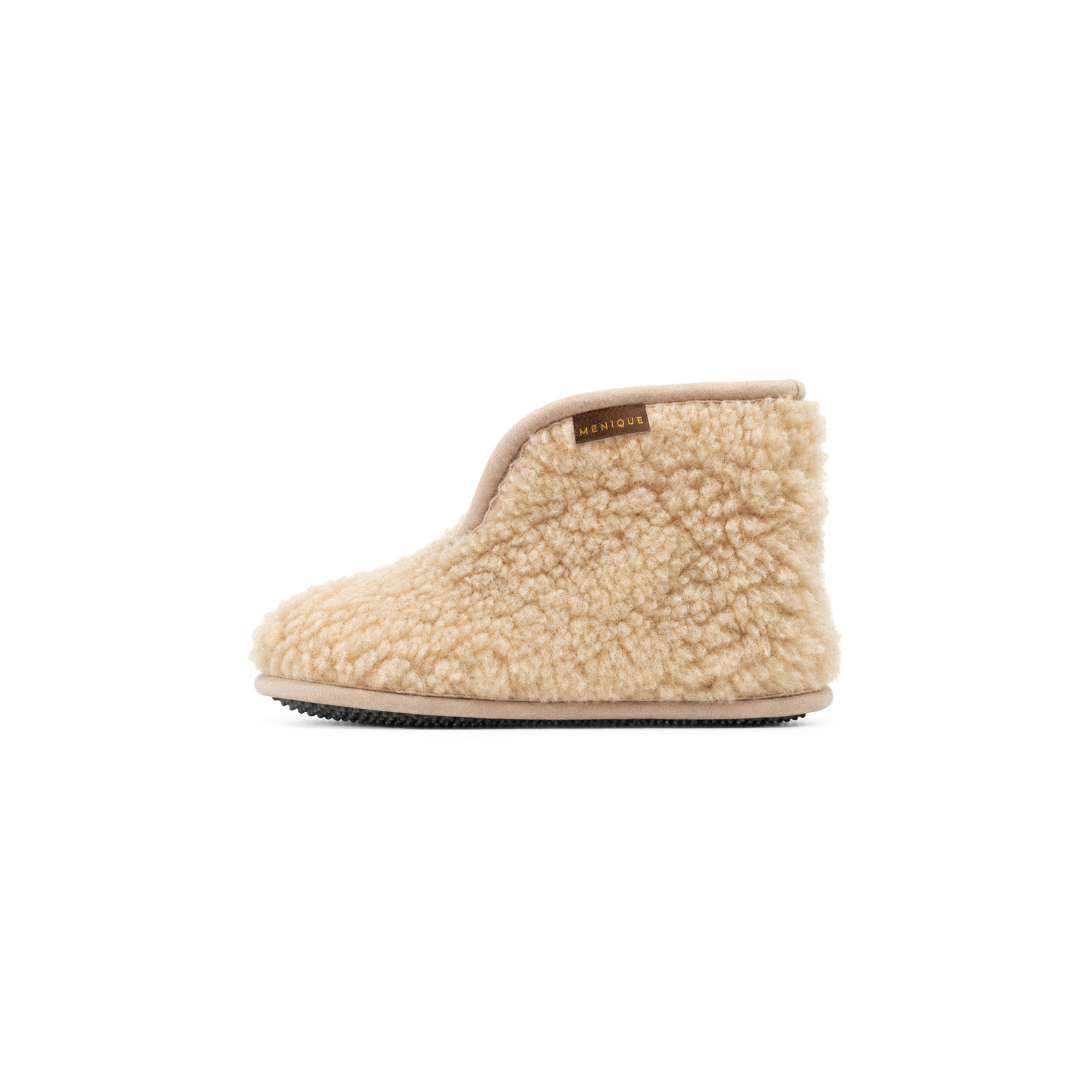 An angled view of a pair of light gray fuzzy ankle bootie slippers. The right slipper has its cuff folded down to reveal a plush cream-colored interior lining, and a "MENIQUE" tag is visible on the edge.